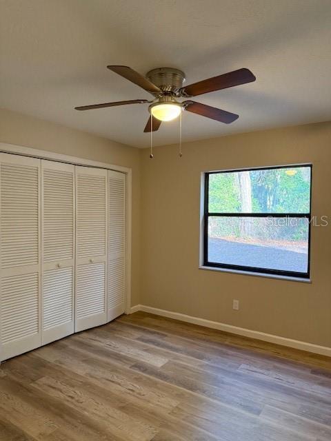 6506 East Mockingbird Lane Inverness, FL 34452 - Photo 8 of 9 a view of an empty room with wooden floor and a window