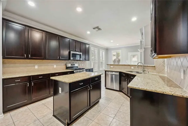 a kitchen with a stove sink and cabinets