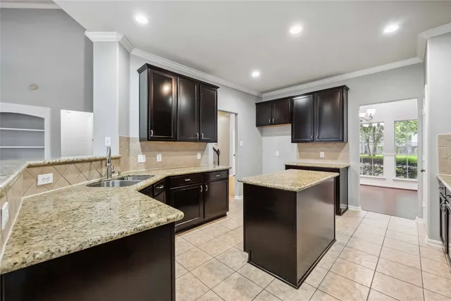 a kitchen with a stove sink and microwave