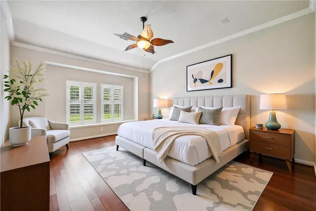 a spacious bedroom with a large bed and a chandelier