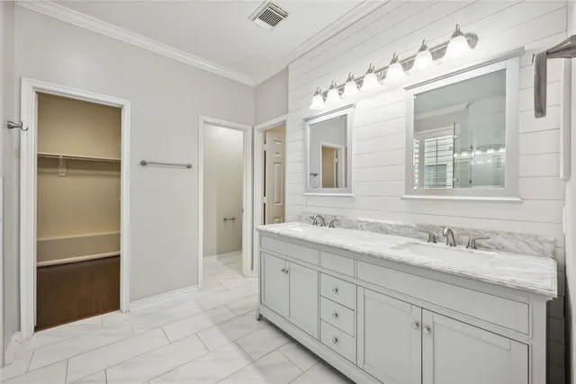 a spacious bathroom with a granite countertop sink mirror and double