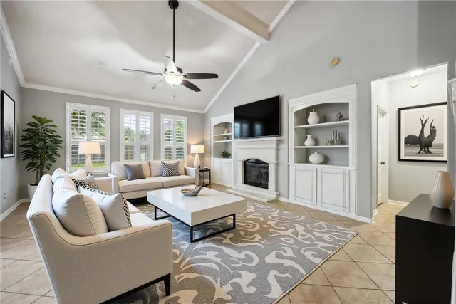 a living room with furniture a fireplace and a flat screen tv