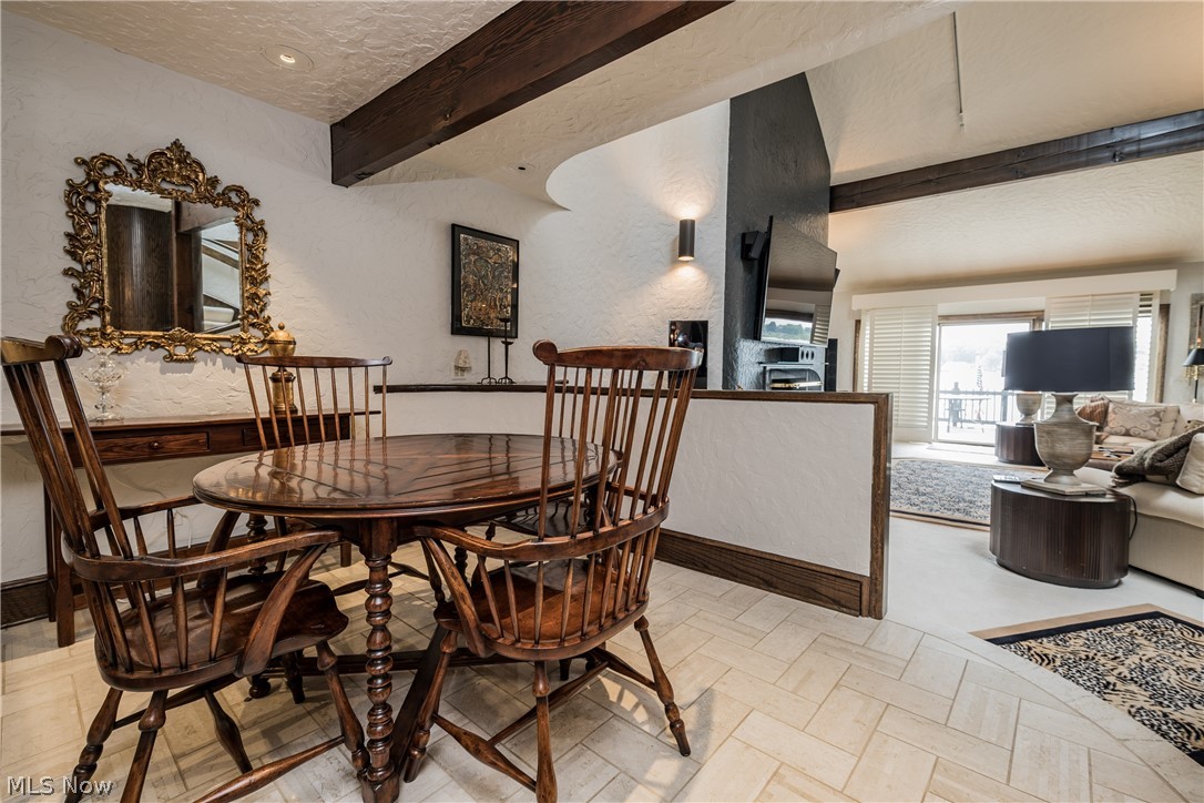 1415 Harbor Drive Northwest Canton, OH 44708 - Photo 14 of 46 Dining room with light tile floors, beam ceiling, and a textured ceiling that opens into the Great Room