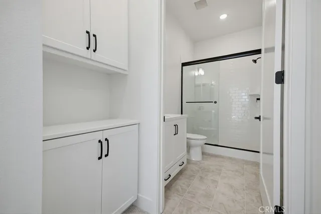 a view of a kitchen with furniture and a refrigerator