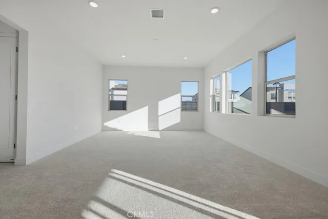a spacious bedroom with a large bed and closet