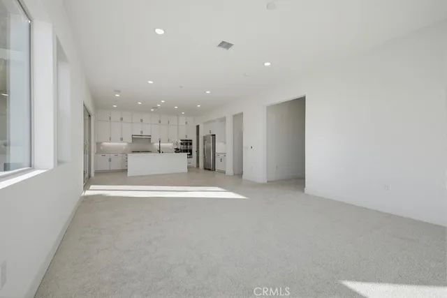 a kitchen with granite countertop a sink a stove and cabinets