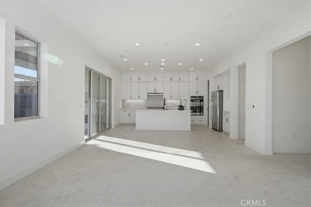a kitchen with granite countertop a sink stove and cabinets
