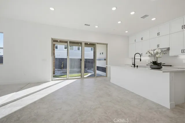a stove top oven sitting inside of a kitchen
