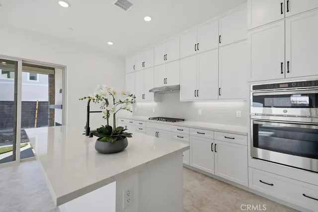 a kitchen with stainless steel appliances and refrigerator