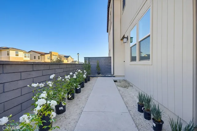a living room kitchen with a dining table and chairs with kitchen appliances