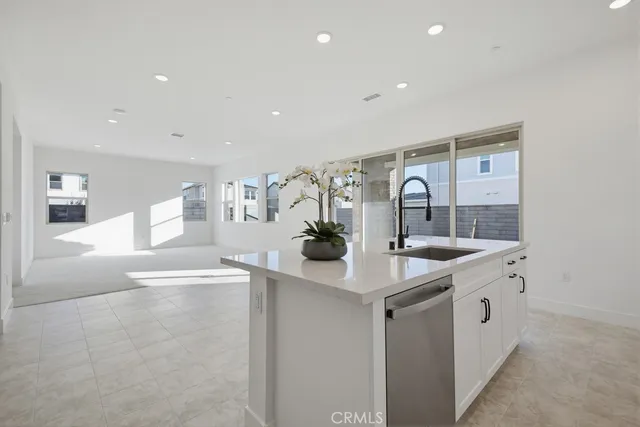a view of a hallway with white cabinets