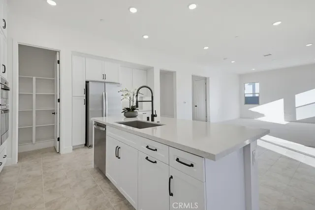 a bathroom with a white tub a sink and mirror