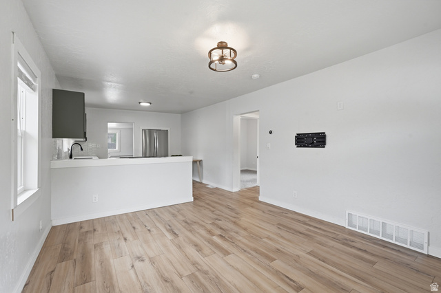 215 East 300 South Logan, UT 84321 - Photo 7 of 32 Unfurnished living room featuring light wood-type flooring and a sink