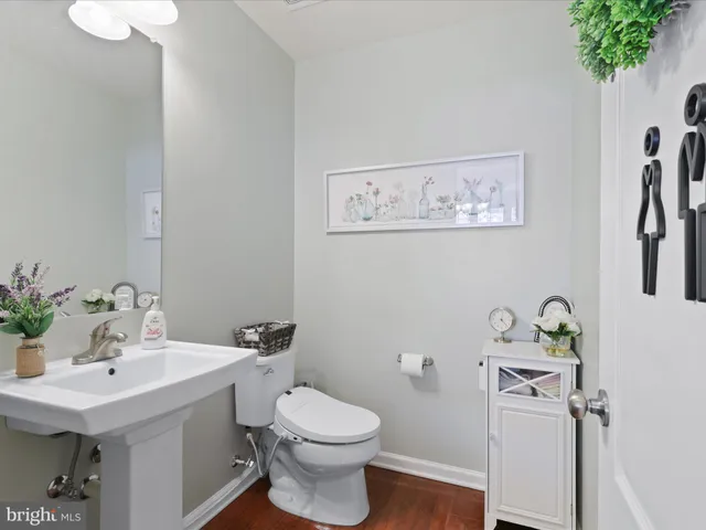 a bathroom with a sink mirror and toilet