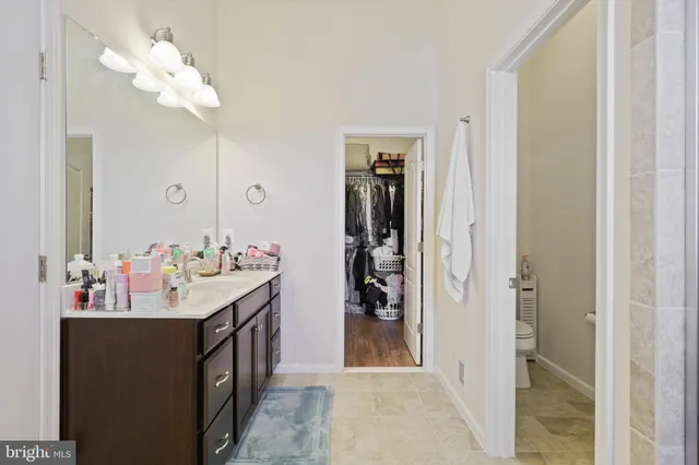 a bathroom with a sink vanity and a mirror
