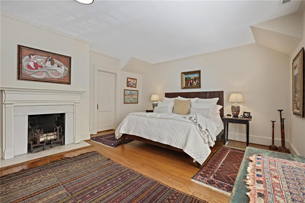 10 Palisades Road Northeast Atlanta, GA 30309 - Photo 21 of 49 a bedroom with a bed and a fireplace