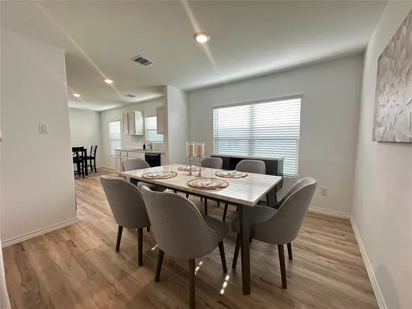 a view of a dining room with furniture window and wooden floor