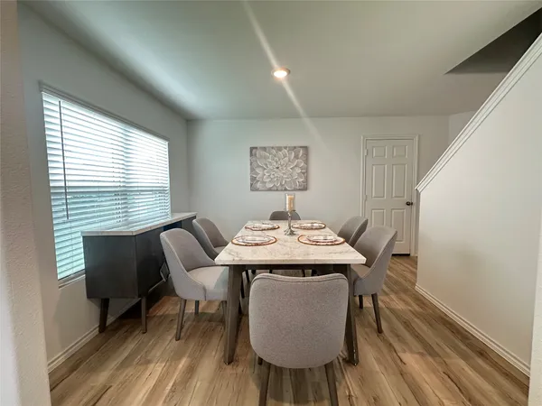 a view of a dining room with furniture window and wooden floor