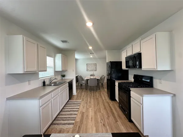 a kitchen with lots of counter top space and stainless steel appliances