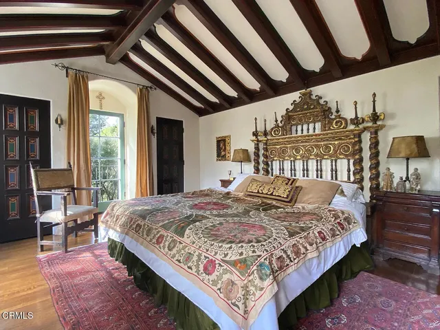 a bed sitting in a bedroom next to a window