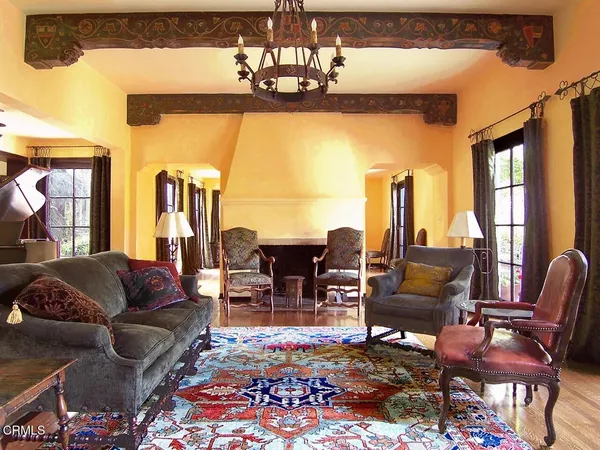 a living room with furniture chandelier and a table