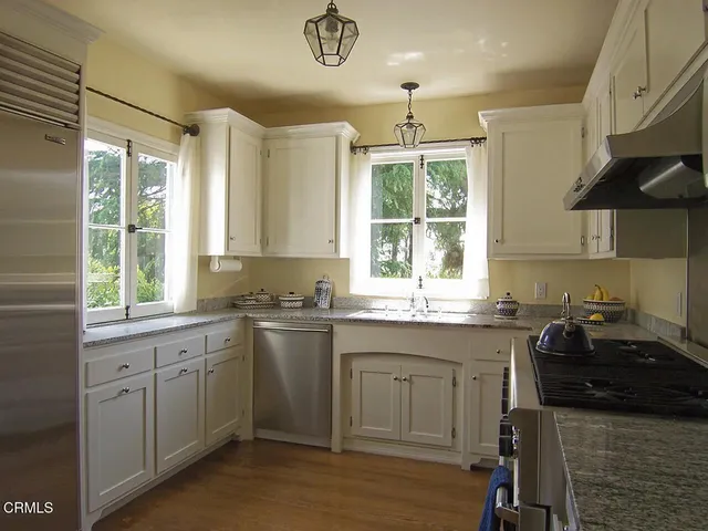 a kitchen with a sink stove and cabinets