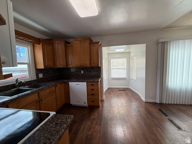 73 Garden Street Helper, UT 84526 - Photo 9 of 36 Kitchen with wood finish cabinets, electric cooktop, white dishwasher, dark wood finished floors, and plenty of natural light