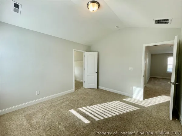 a view of walk in closet with empty racks