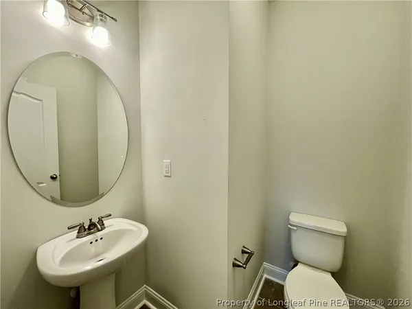 an empty room with a window and a ceiling fan