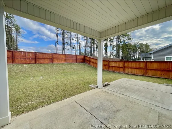 a view of an house with backyard space and balcony