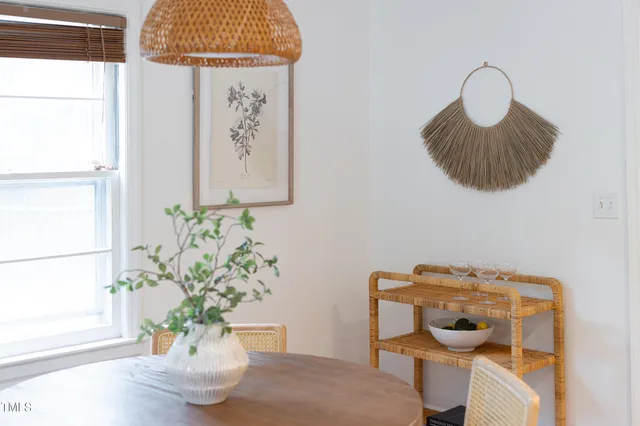 a view of a dining room with furniture and a window