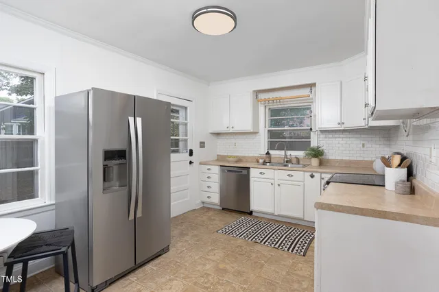 a kitchen with stainless steel appliances white cabinets and a granite counter tops