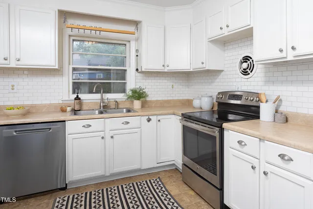 a kitchen with a refrigerator sink stove and microwave