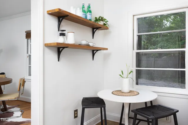 a kitchen with a table chairs and refrigerator