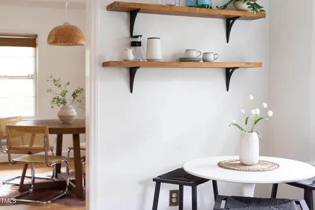 a view of a room that has a table and chairs in it