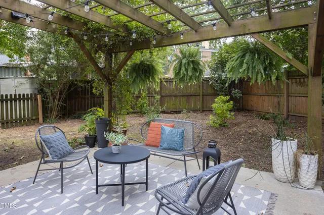 a view of a chairs and table in the back yard