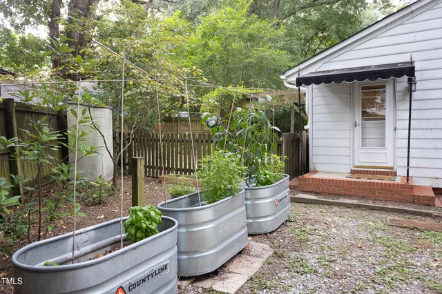 a backyard of a house with table and chairs