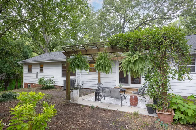 a view of a patio with a table and chairs under an umbrella