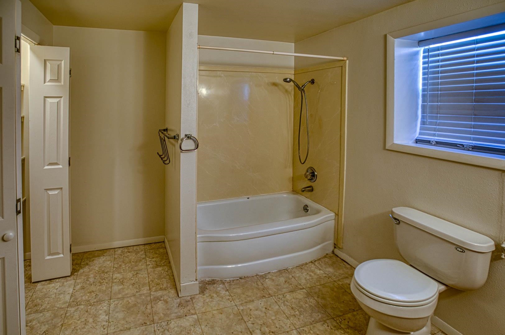 1179 17 Road Fruita, CO 81521 - Photo 12 of 36 a white toilet sitting next to a bath tub