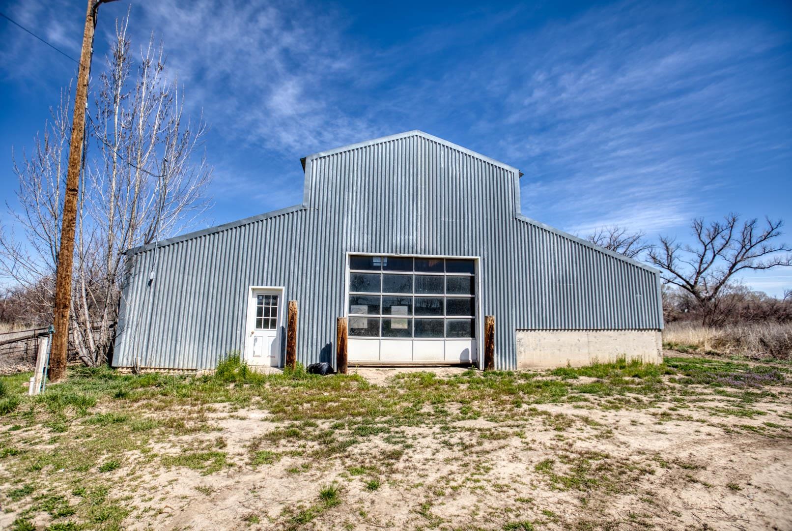 1179 17 Road Fruita, CO 81521 - Photo 36 of 36 a house with wooden fence next to a road