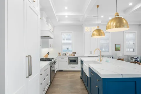 a kitchen with a sink a stove and a wooden floors