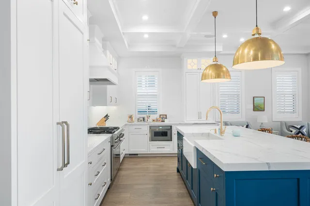 a kitchen with a sink a stove and a wooden floors