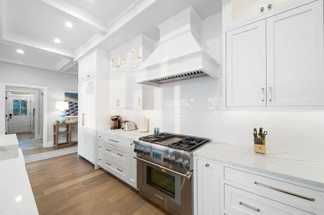 a kitchen with stainless steel appliances white cabinets and a stove