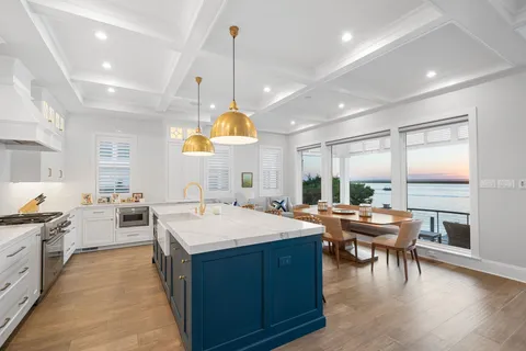 a large kitchen with a table and chairs