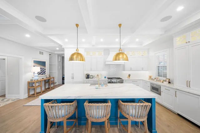 a dining room with furniture a chandelier and wooden floor