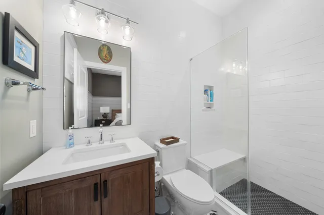 a bathroom with a toilet sink and mirror