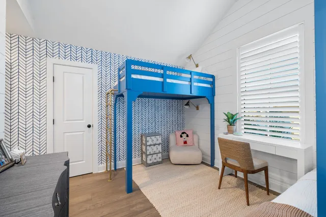 a bedroom with a bunk bed and a chair