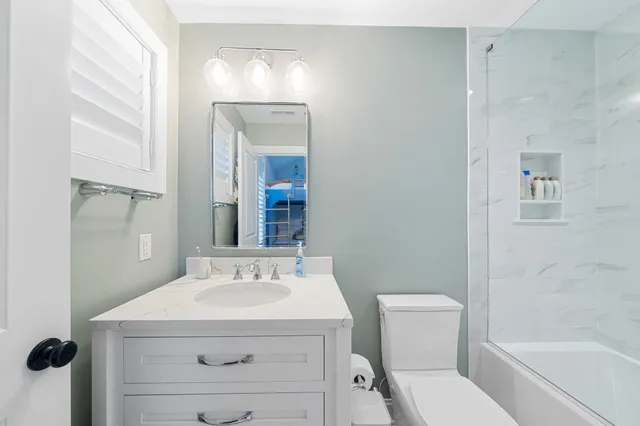 a bathroom with a sink toilet and shower