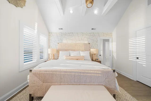 a bedroom with a large bed and a window