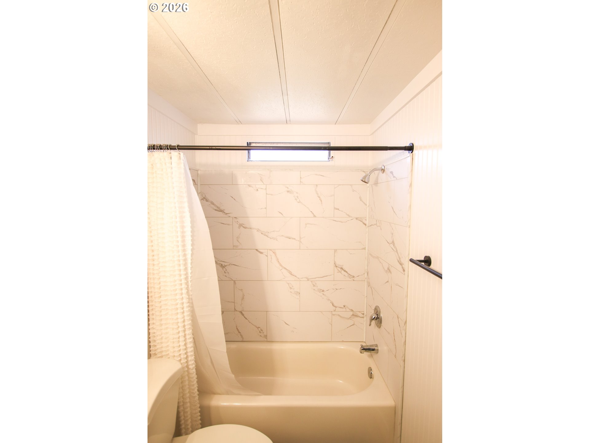 1431 Maple Street Florence, OR 97439 - Photo 43 of 43 a bathroom with a shower and a bathtub
